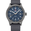 Swiss Military SM34108.05 Classic Army Style Watch with blue dial, stainless steel case with grey sandblast finish, luminous Arabic numerals, additional military hours, and a grey canvas strap.